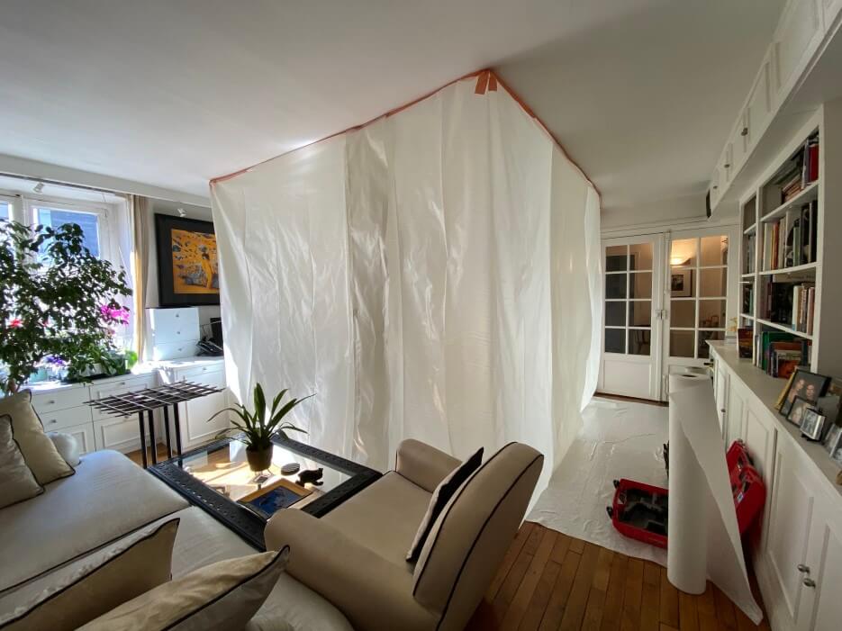 Adrian Leeds' apartment living room tented in plastic to examine the cracks in the ceiling