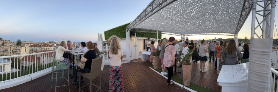 Conference attendees on the rooftop of the Hôtel Spendid for a final cocktail party