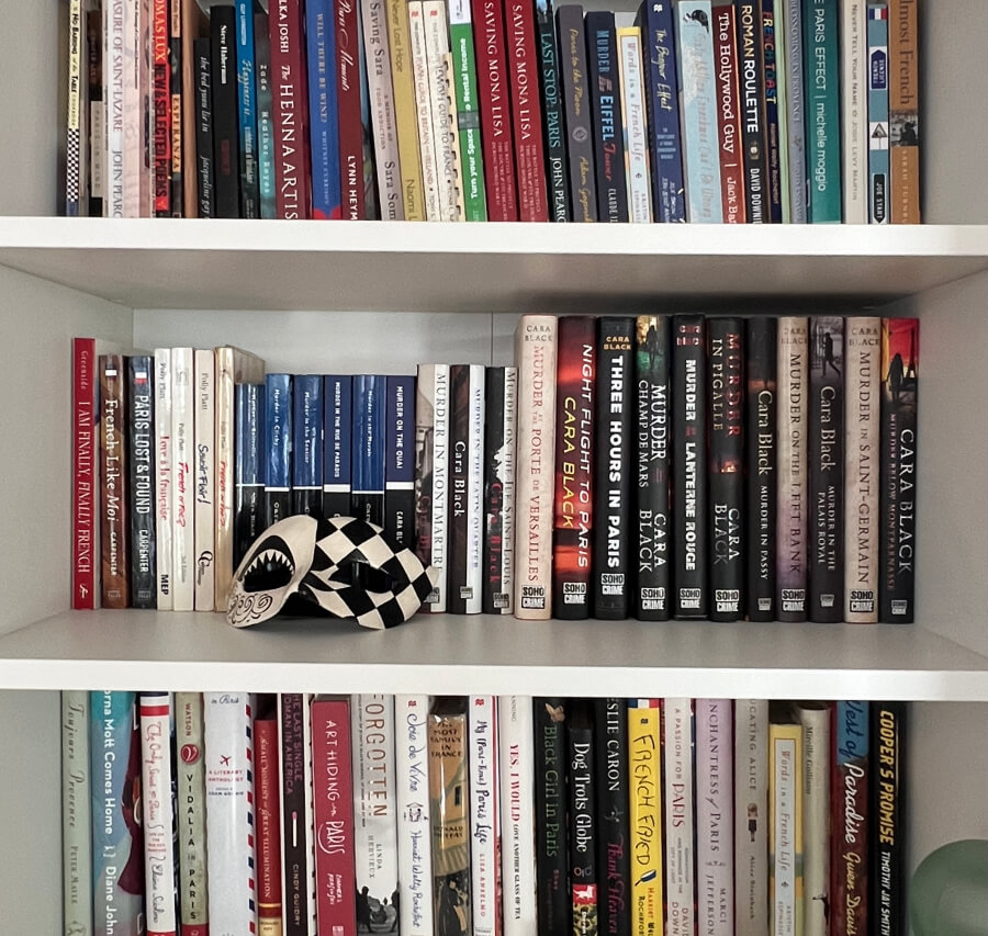 Adrian Leeds' bookshelves filled with books by Cara Black
