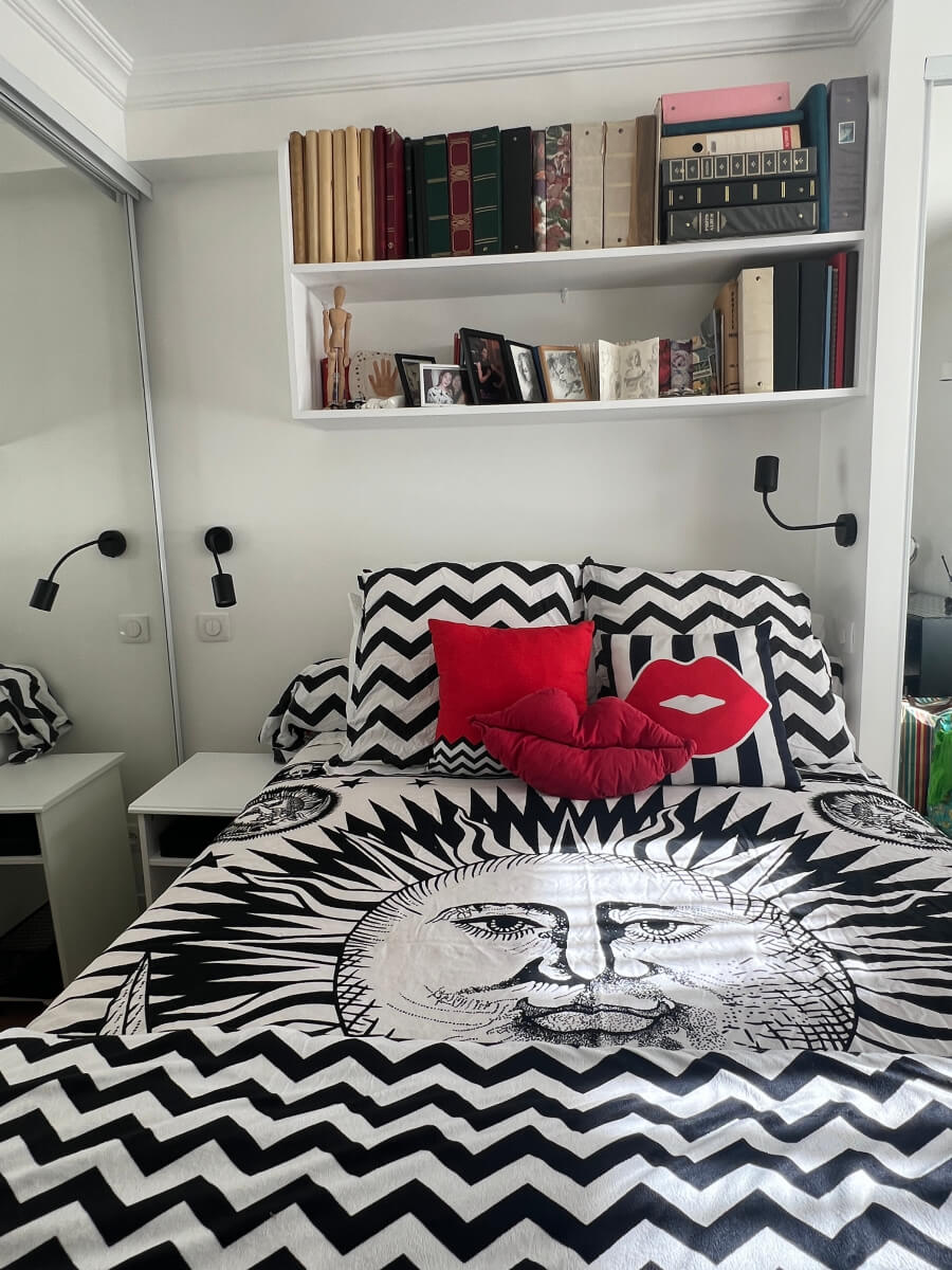 Photo albums on the shelves in Erica Simone's room in Adrian Leeds' Paris apartment