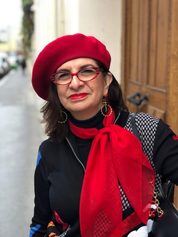 Adrian Leeds in Paris wearing a red scarf and a red beret
