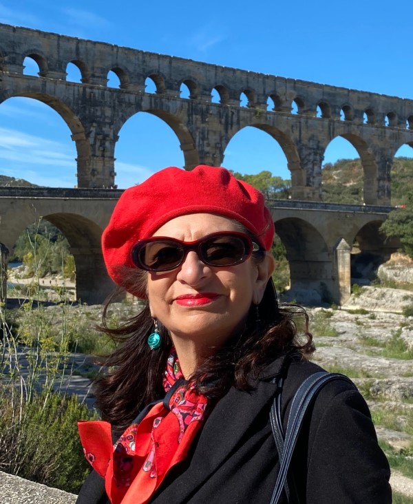 Adrian leeds wearing a red beret at the Pont du Gard