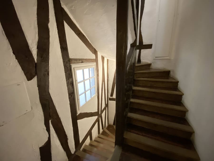 Historical stairwell with exposed beams at rue François Miron