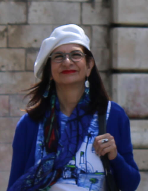 Adrian Leeds dressed in blue and white with a signature white beret