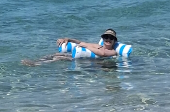 Adrian Leeds on a floating lounge chair at Aregno Plage