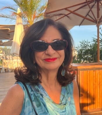 Adrian Leeds sitting at a beachside restaurant in Nice, France