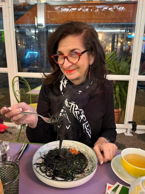 Adrian Leeds eating squid ink pasta