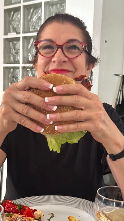Adrian Leeds eating a burger to celebrate the 4th of July