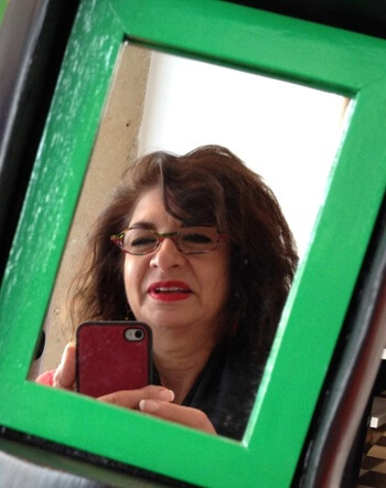 Adrian Leeds reflected in a framed mirror