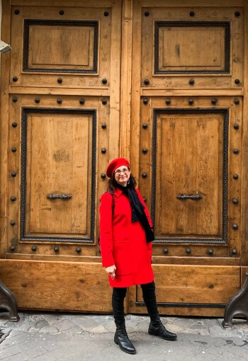 Adrian Leeds in front of her wooden, double door doorway to her Saintonge apartment building