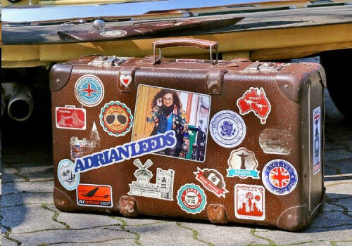 Adrian Leeds' suitcase covered in travel stickers