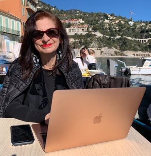 Adrian Leeds on her laptop in Villafranche-ser-Mer, France