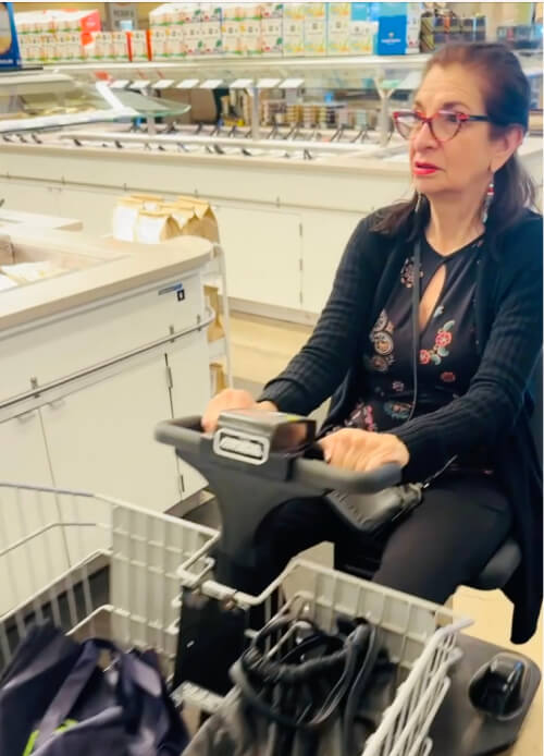 Adrian Leeds in a motorized cart at Whole Foods