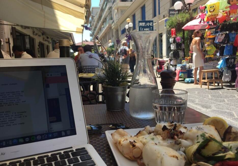 Adrian Leeds on her laptop at a café in Nice