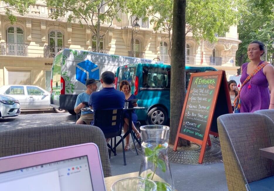 Neighborhood sidewalk scene at a cafe in Paris