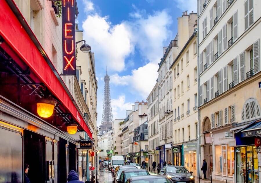 View of the Eiffel Tower down a street in Paris, France