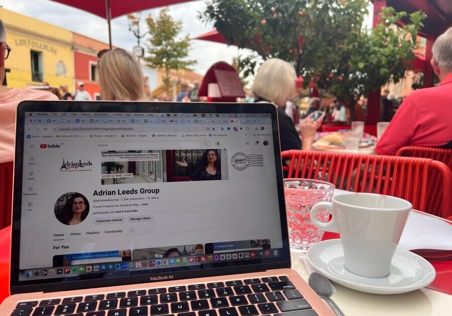 Adrian Leeds' laptop open on a cafe table in Paris