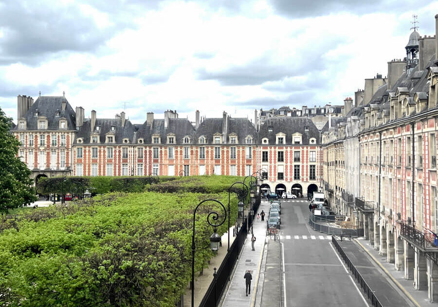 View of Place des Vosges in front of Maison Victor Hugo in Paris