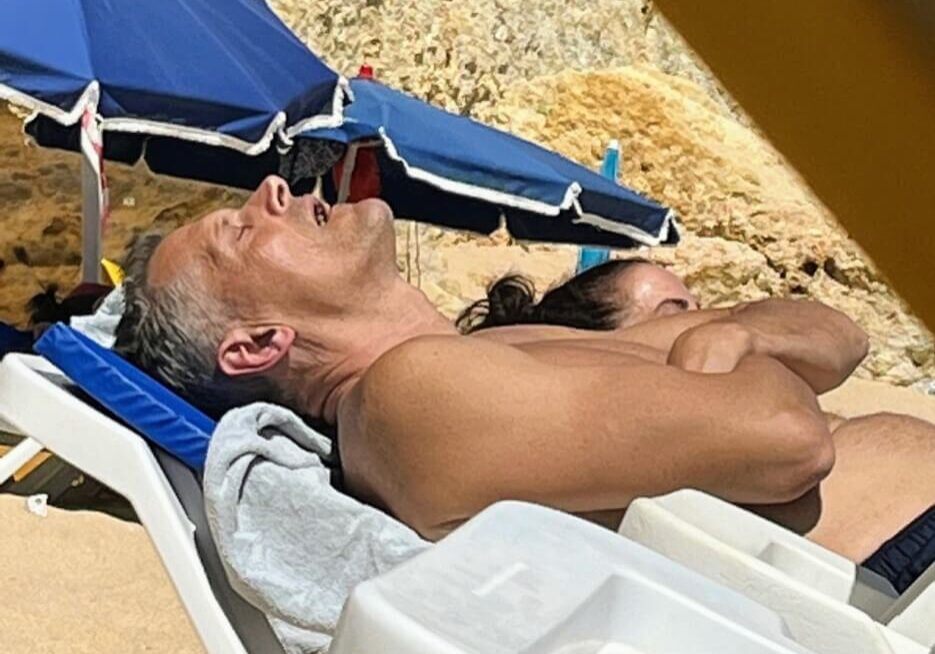 Man sound asleep on the beach, mouth open