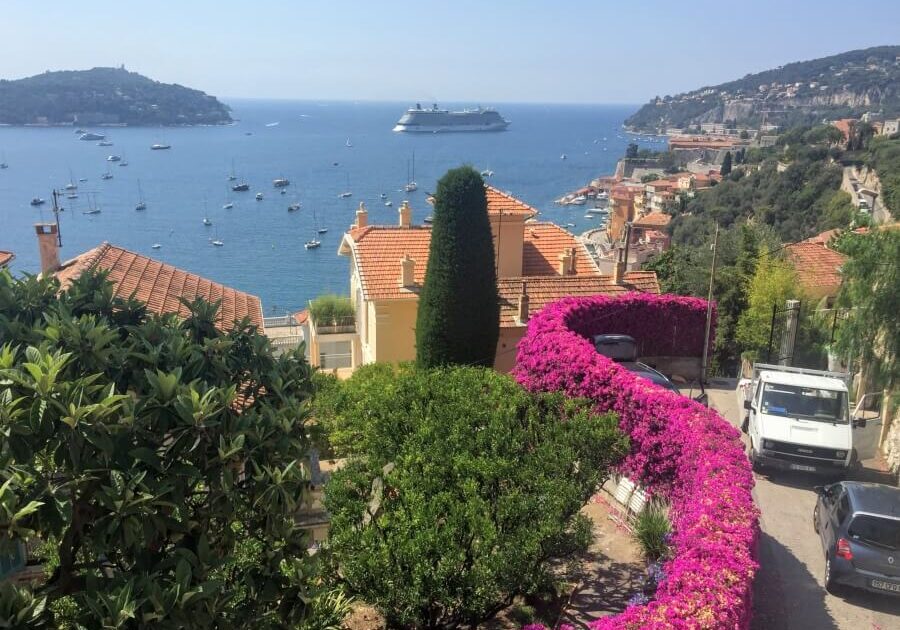 A winding road on the French Riviera with a view of the sea