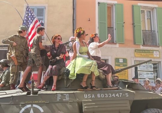 The 81st anniversary parade with people in period costume on a tank