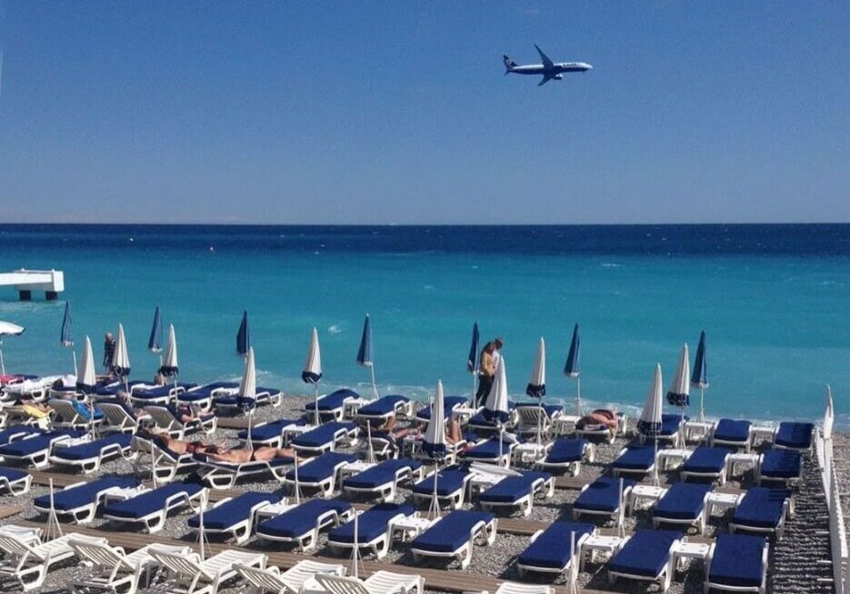Blue and white beach chairs and lounges on the beach in Nice, France