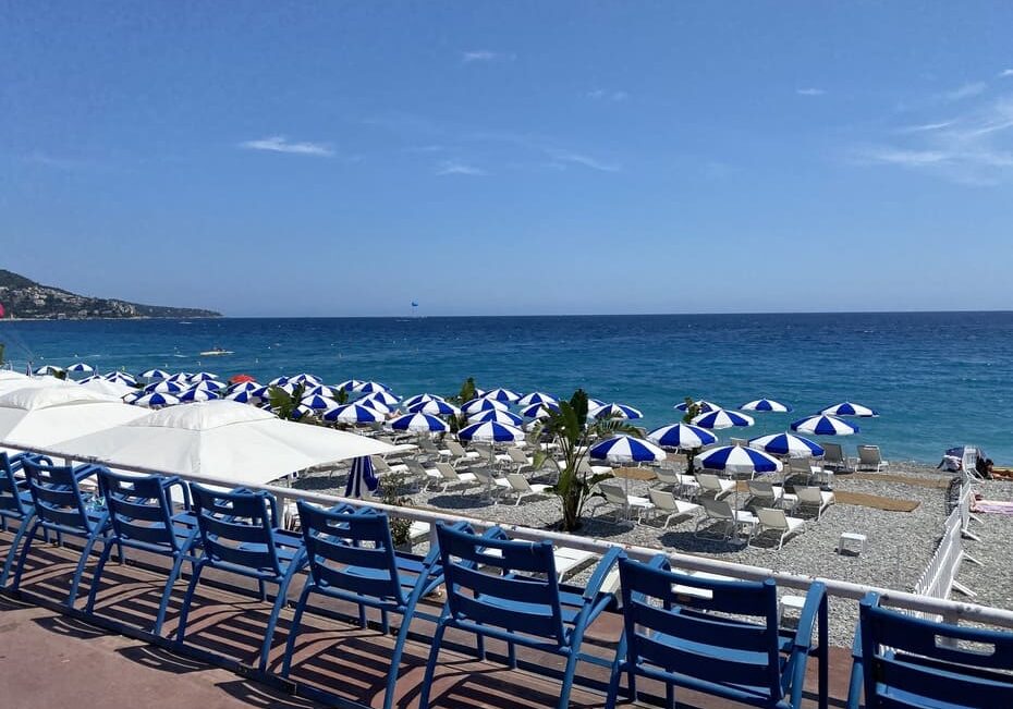 Beach chairs, umbrellas, and the sea in Nice, France