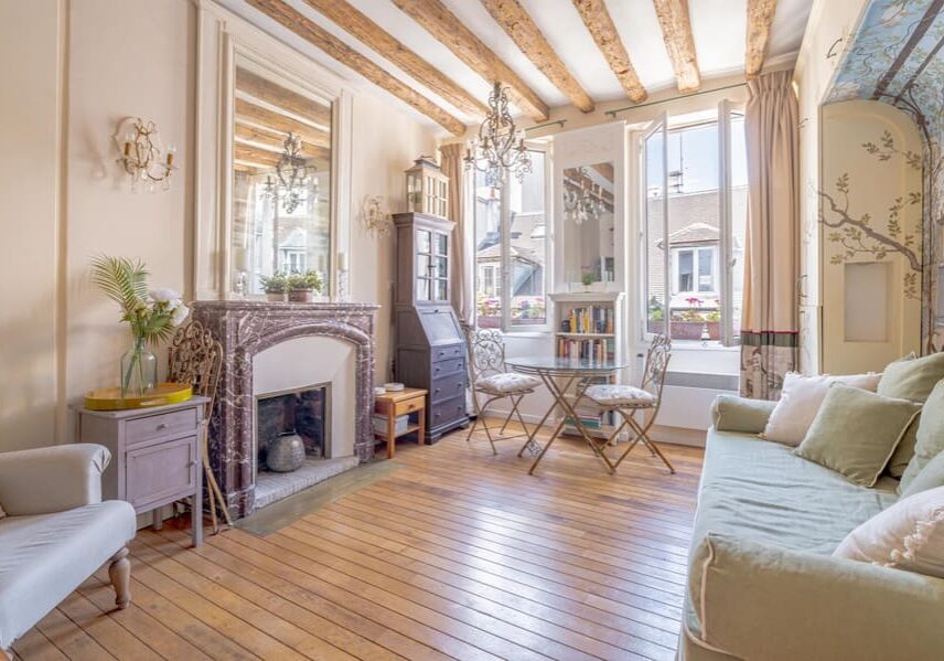 Fireplace, exposed beams, wood floor custom cabinets, large windows and fully furnished by designer at 50 rue Volta Paris