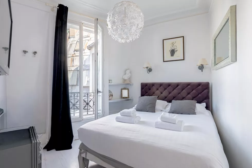 Bright bedroom with large window at 9 rue Lagrange Paris 75005