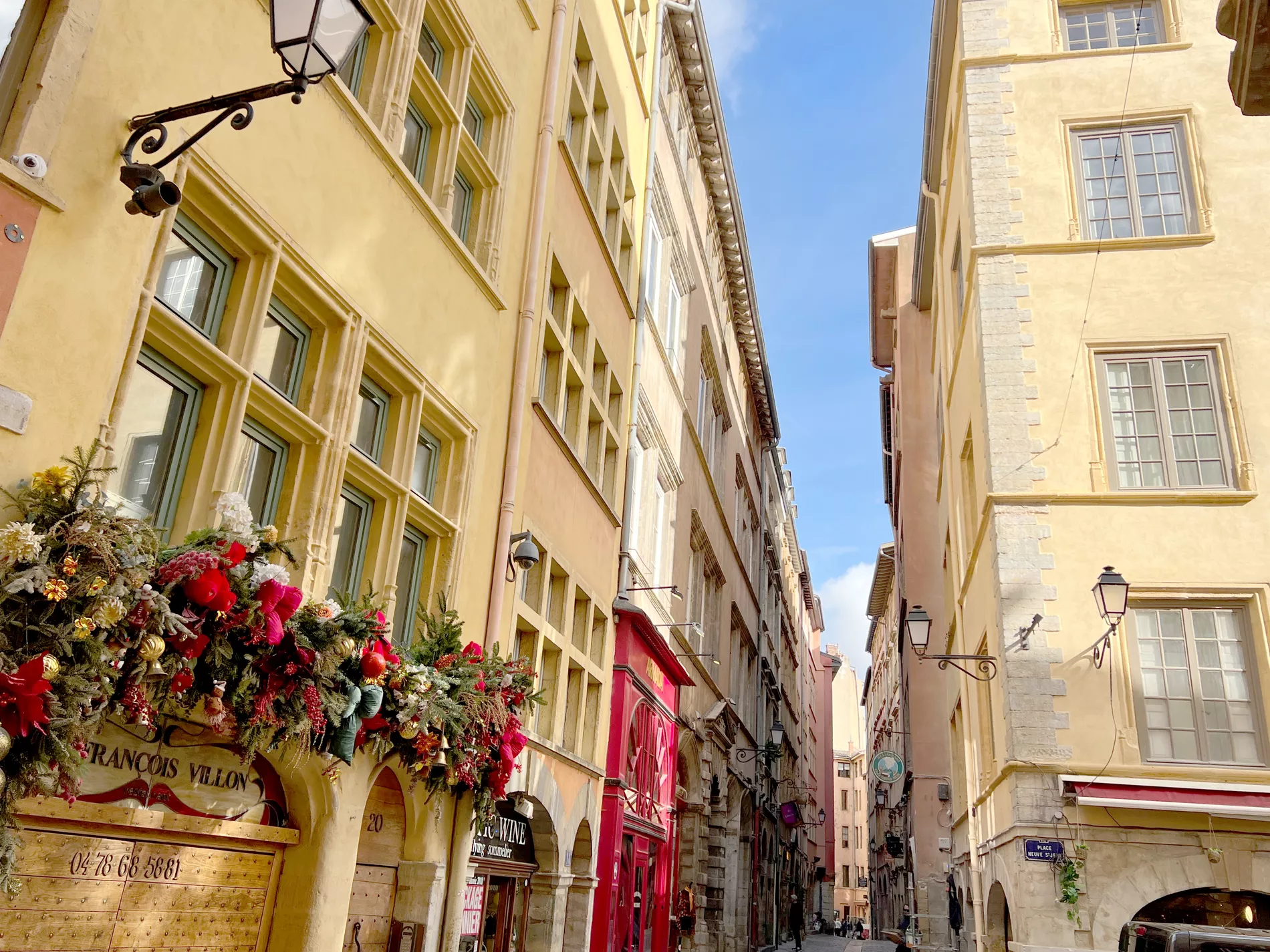 Beautiful cozy old town street with shops and flowers in France