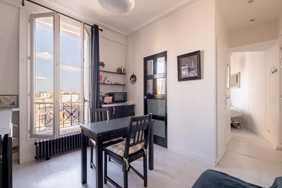 Bright living, dining, and kitchen area with views of Paris and Notre Dame 9 rue Lagrange Paris 75005