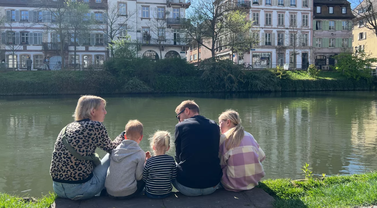 strasbourg family sitting next to the river