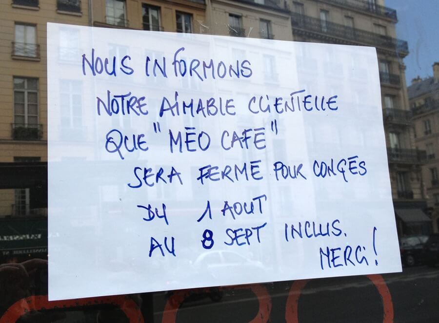 Sign in a Paris shop window announcing their summer closure