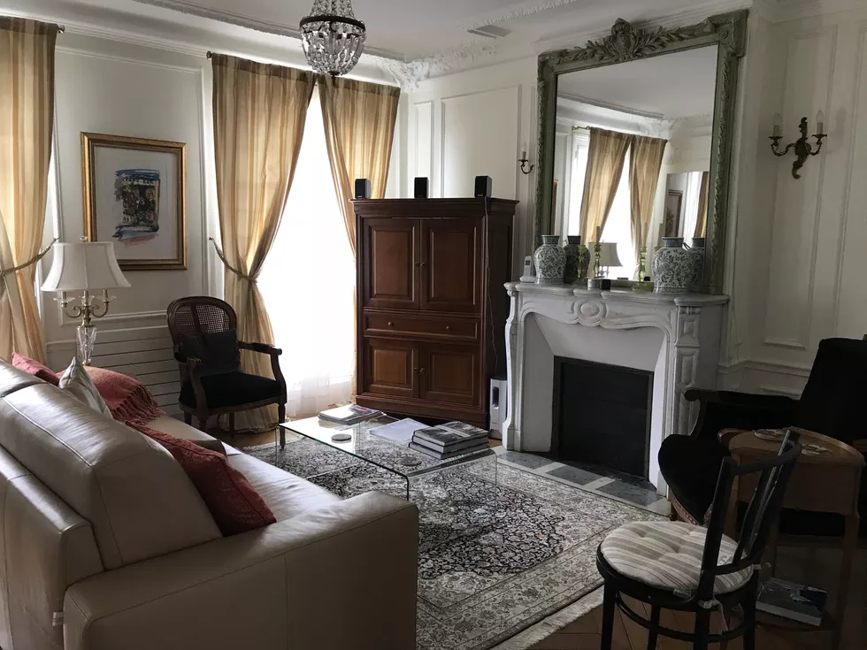 Windows and views in living room with fireplace at Le Petit Tresor