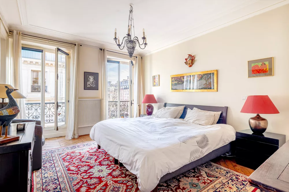 Large main bedroom Rue de Palestro with hardwoods, large windows, bathroom and storage Paris France