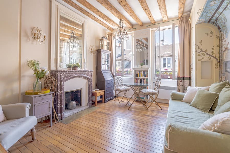 Fireplace, exposed beams, wood floor custom cabinets, large windows and fully furnished by designer at 50 rue Volta Paris