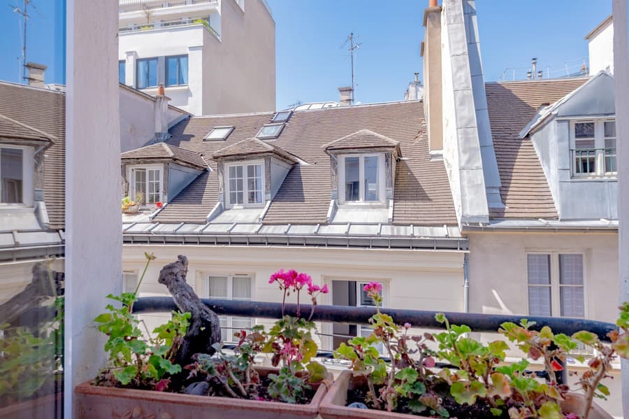 Window boxes with flowers and views at rue Volta Paris apartment