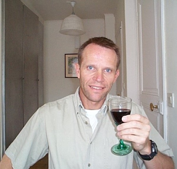 Schuyler Hoffman in his apartment in Paris toasting the completion of a French Property Insider edition